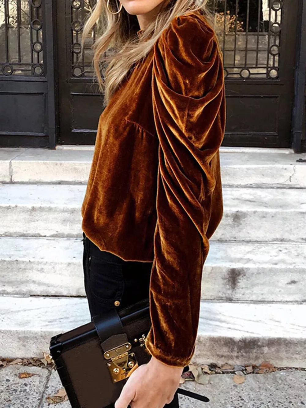 Brown velvet mock neck blouse with ruffled puff sleeves.