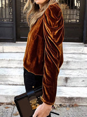 Brown velvet mock neck blouse with ruffled puff sleeves.