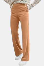 Caramel wide leg trousers with button detail at the waist.