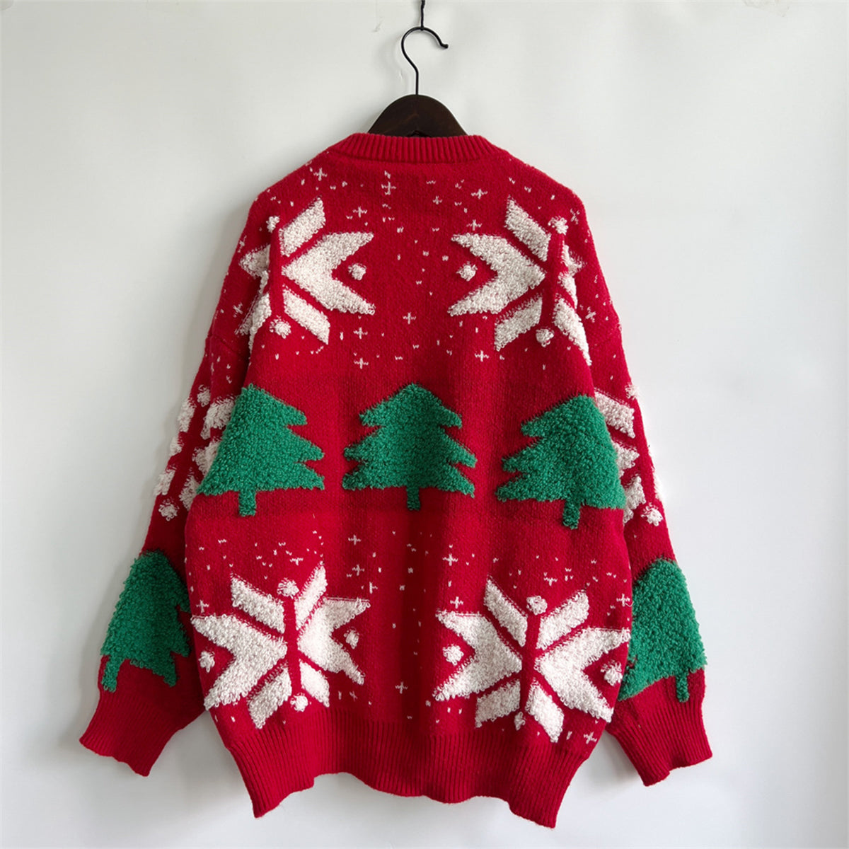 Red acrylic knit sweater with festive Christmas tree and snowflake appliqué details.