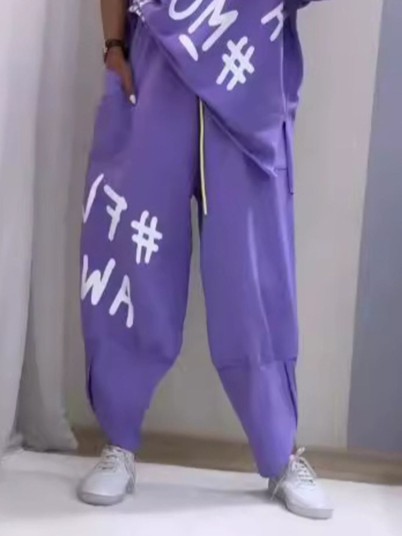 Purple graphic tee and drawstring pants set with white text and yellow drawstring.