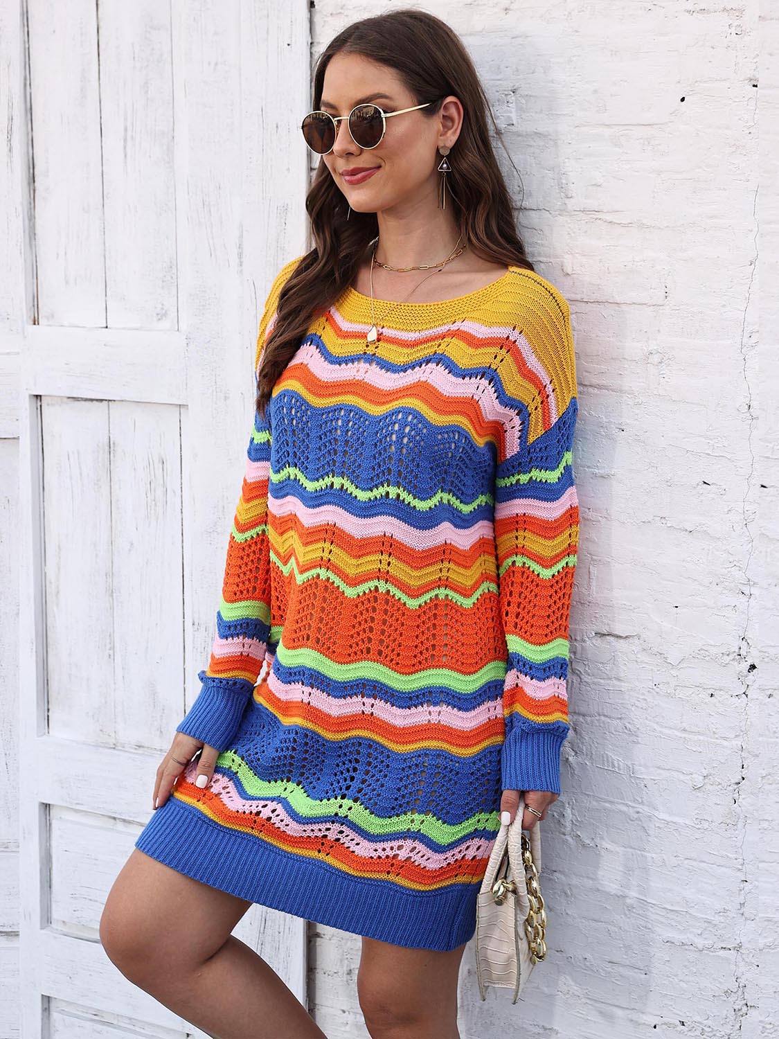 Chevron stripe knit mini dress with a crochet detail and a colorful striped pattern.