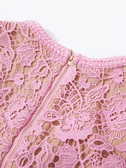 Pink lace midi dress with zipper detail and textured neckline.