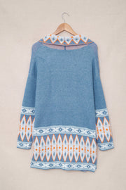 Blue knit cardigan with geometric trim on collar and sleeves.