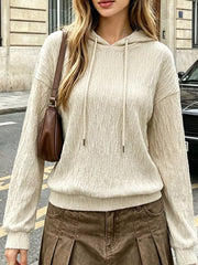 Textured apricot hoodie with drawstring and dropped shoulders.