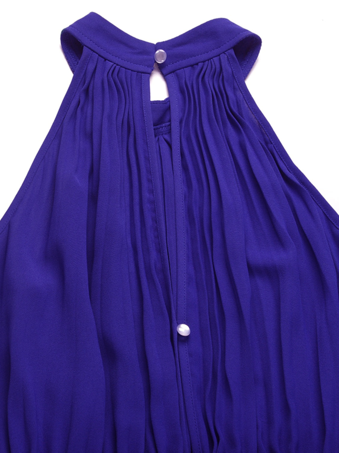 Halter neckline pleated jumpsuit in royal blue with keyhole and button detail.