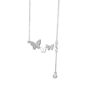 Delicate silver necklace with three sparkling butterfly charms and a dangling zircon accent.