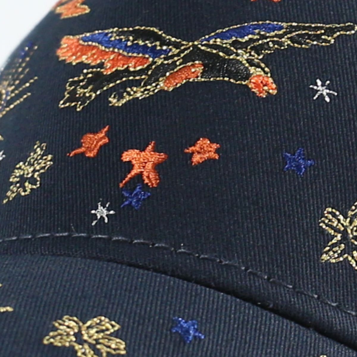 Navy blue cotton baseball cap with intricate embroidered eagle and star pattern.