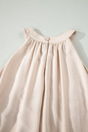 Beige halter maxi dress with gathered neckline and button closure at back neck