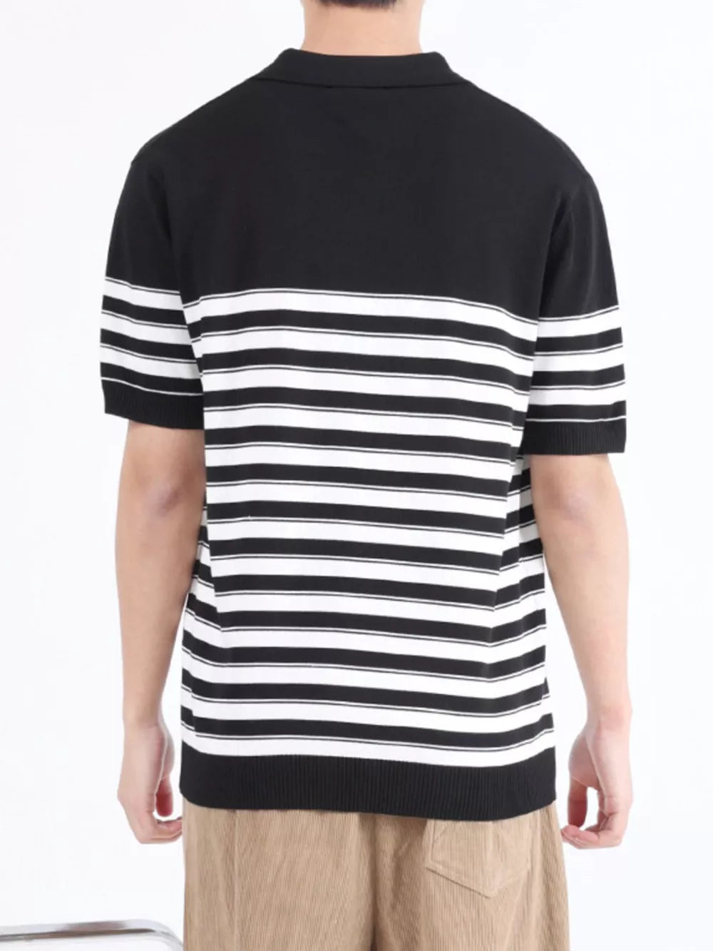 Men's black and white striped knit polo shirt with short sleeves and a collar.
