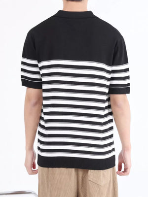 Men's black and white striped knit polo shirt with short sleeves and a collar.