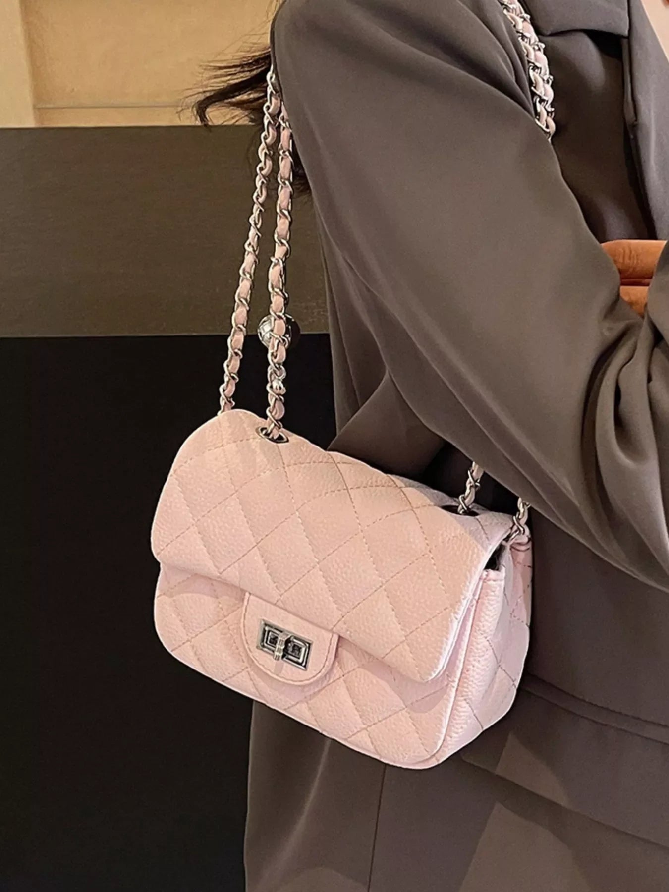 Pink quilted chain crossbody clutch with silver hardware