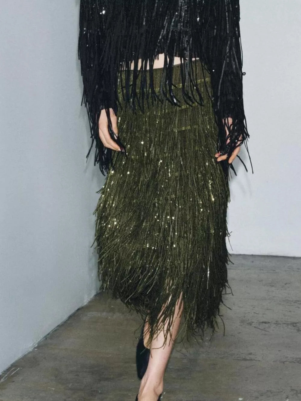 Fringe embellished two-piece outfit set with army green skirt and black sequin fringe jacket.