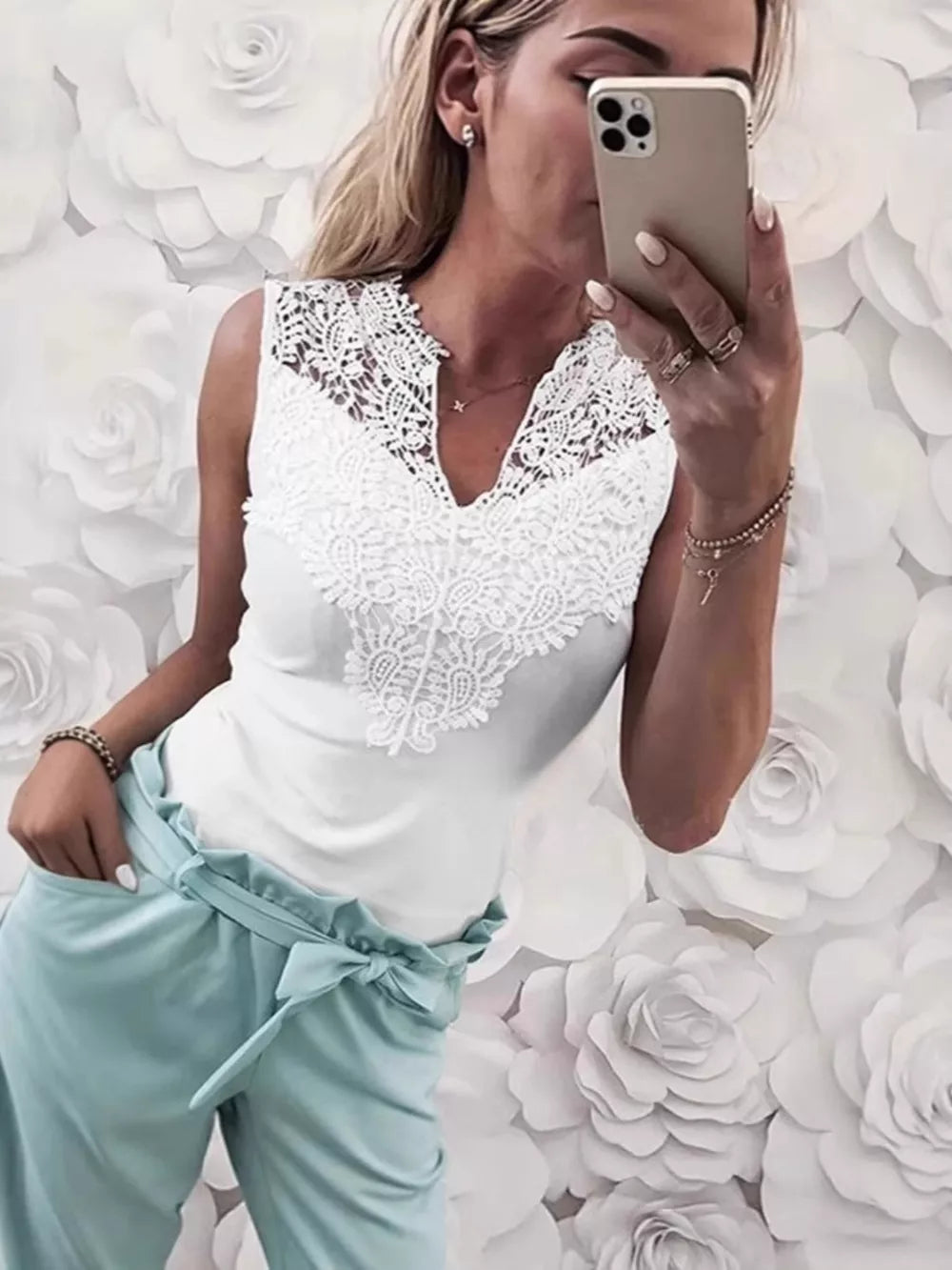 White lace-embellished notched V-neck tank top with sleeveless cut.