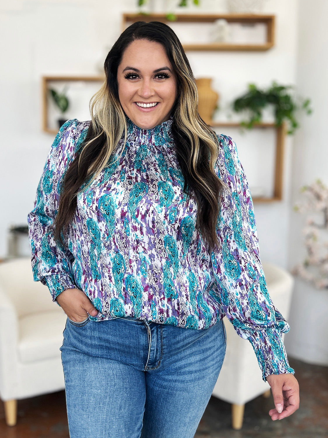 High neck abstract print blouse in sky blue and red-violet with smocked cuffs and neckline.