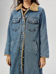 Denim maxi coat in medium wash with shearling trim and button closure.