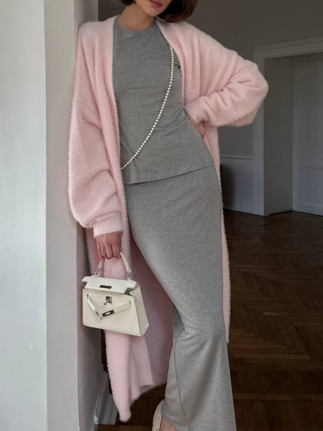 Plush maxi cardigan in blush pink with balloon sleeves, worn open over a grey top and skirt.
