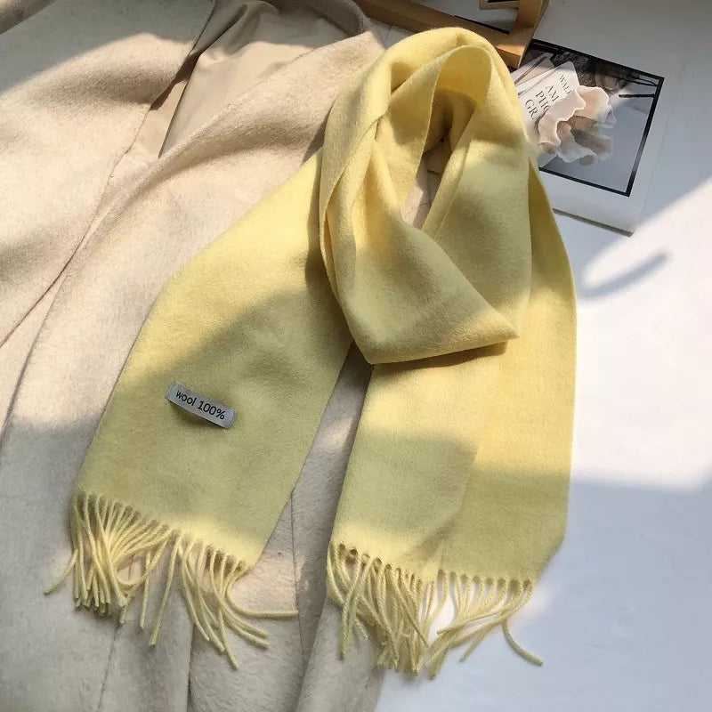 Luxurious wool knit scarf in Cream Yellow with fringes and a 100% wool tag.