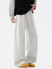 Light gray casual drawstring pants with a relaxed fit and subtle text detail.