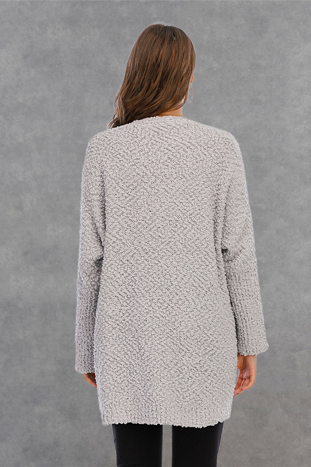 Light gray textured cocoon cardigan with patch pockets and long sleeves.