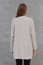 Light gray textured cocoon cardigan with patch pockets and long sleeves.