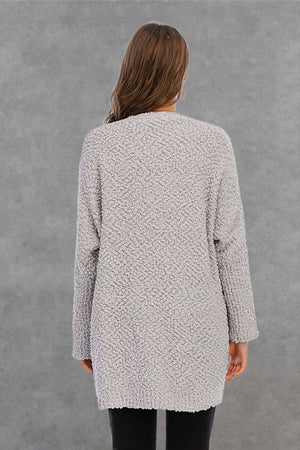 Light gray textured cocoon cardigan with patch pockets and long sleeves.