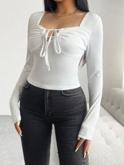 White ruched bustier long sleeve top with tie detail and square neckline