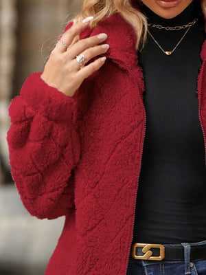 Textured teddy zip-up jacket in deep red with quilted pattern detail.