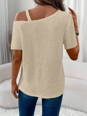 Beige waffle knit one-shoulder t-shirt with cutout detail and short sleeves.