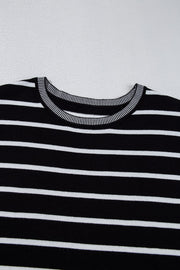 Black and white striped knit tee with contrast ribbed neckline and cuffs.