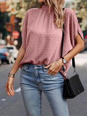 Dusty Pink textured dot back-tie blouse with short sleeves and mock neck.