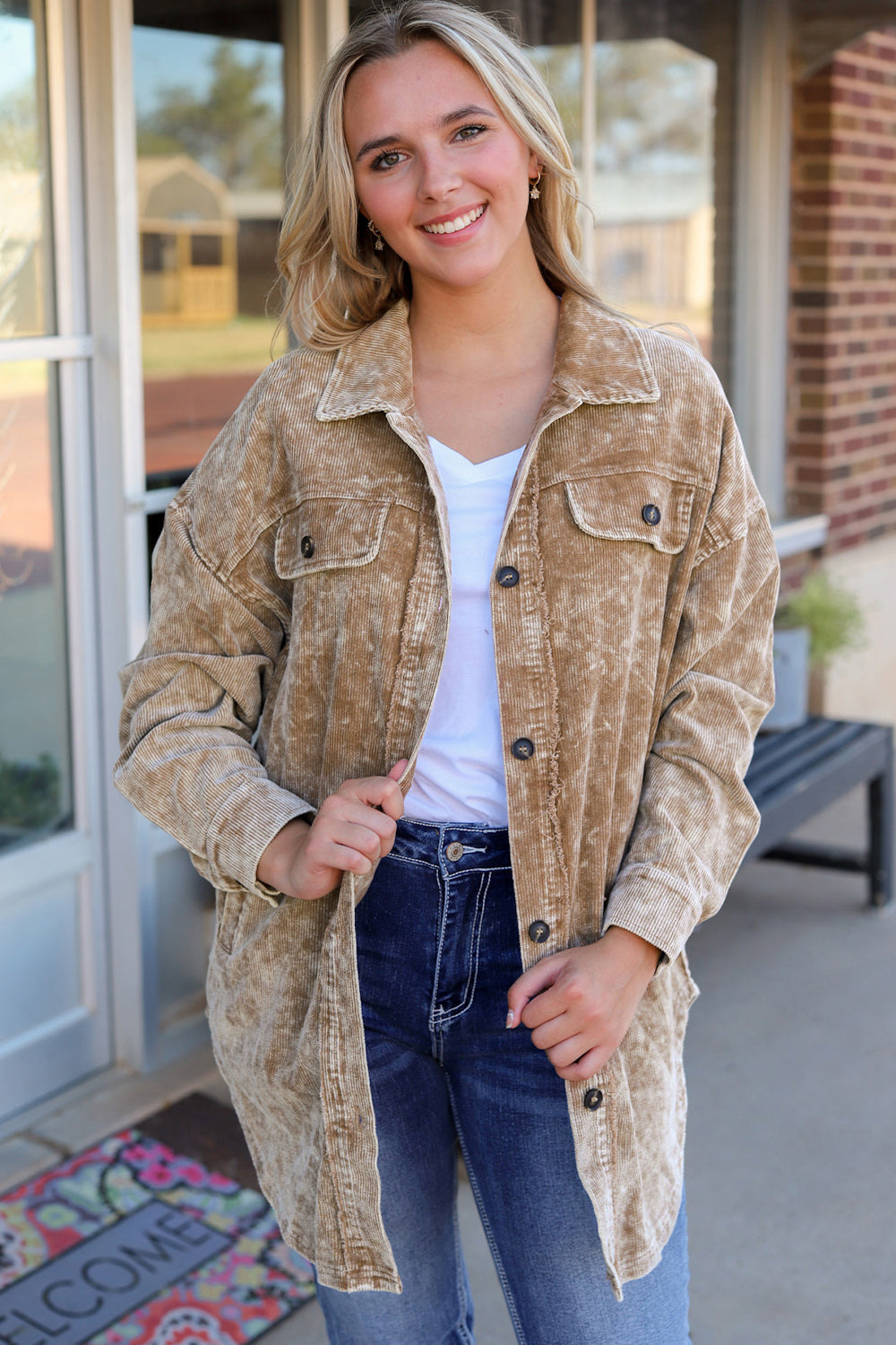 Camel textured corduroy overshirt with faded wash, button front, and chest pockets.