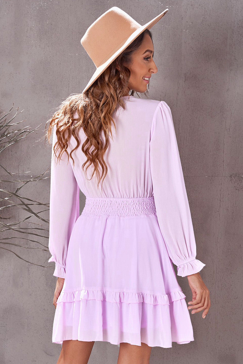 Pink Lavender mini dress with smocked waist, ruffled hem, and long sleeves.