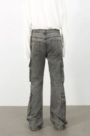 Acid wash flared cargo denim pants in medium, featuring multiple pockets and a relaxed fit.