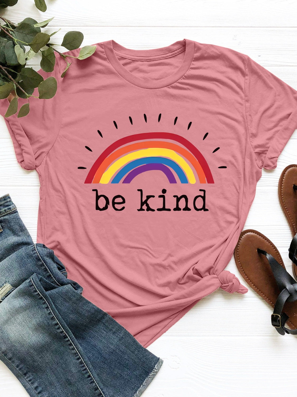 Coral crew neck t-shirt with rainbow graphic and "be kind" text