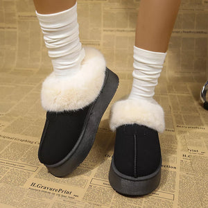 Plush suede platform ankle boots in black with cream faux fur trim and white slouch socks.