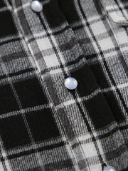 Oversized button-up shirt in black and white plaid cotton with pearl buttons.