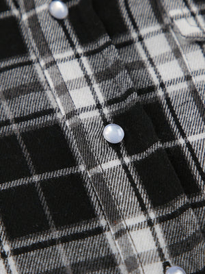 Oversized button-up shirt in black and white plaid cotton with pearl buttons.