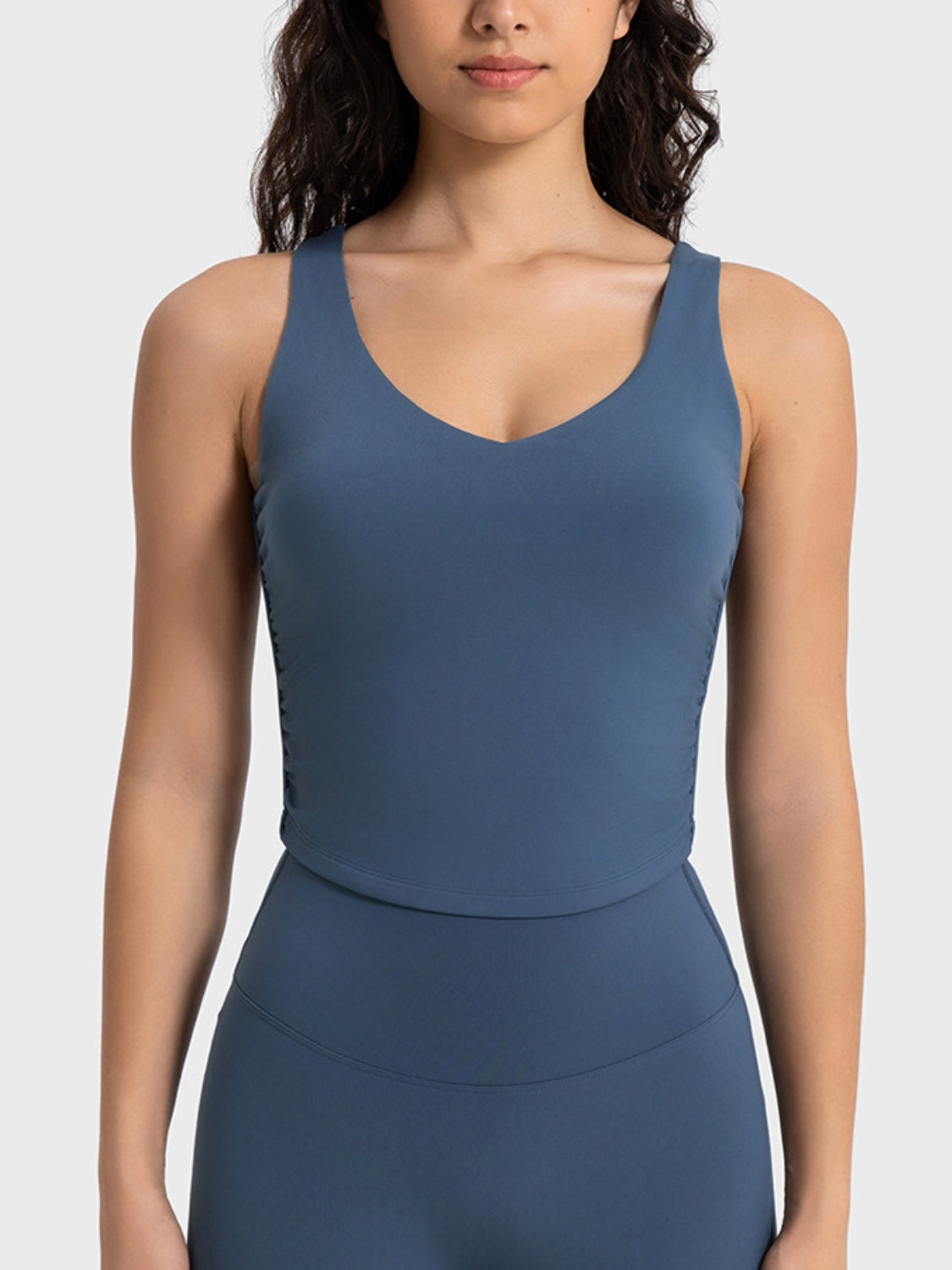 Sculpted ruched tank top in peacock blue with V-neck and athletic fit.