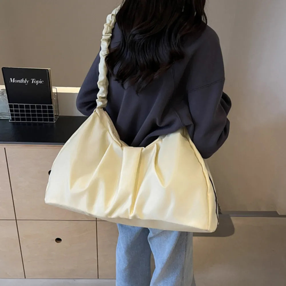 Ivory ruched handle crescent shoulder bag with a casual, slouchy style.