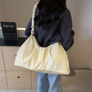 Ivory ruched handle crescent shoulder bag with a casual, slouchy style.