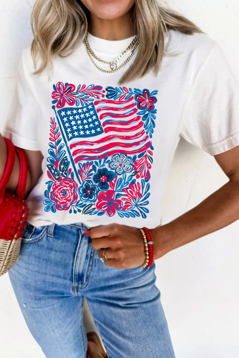 White polyester t-shirt with patriotic floral American flag graphic.