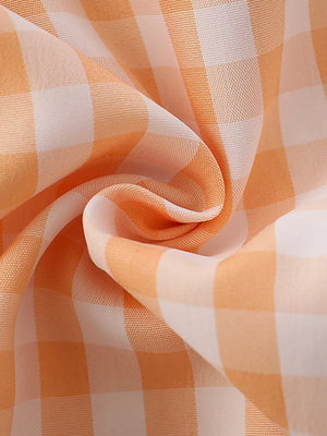 Orange and white gingham cotton fabric with ruffle detail.