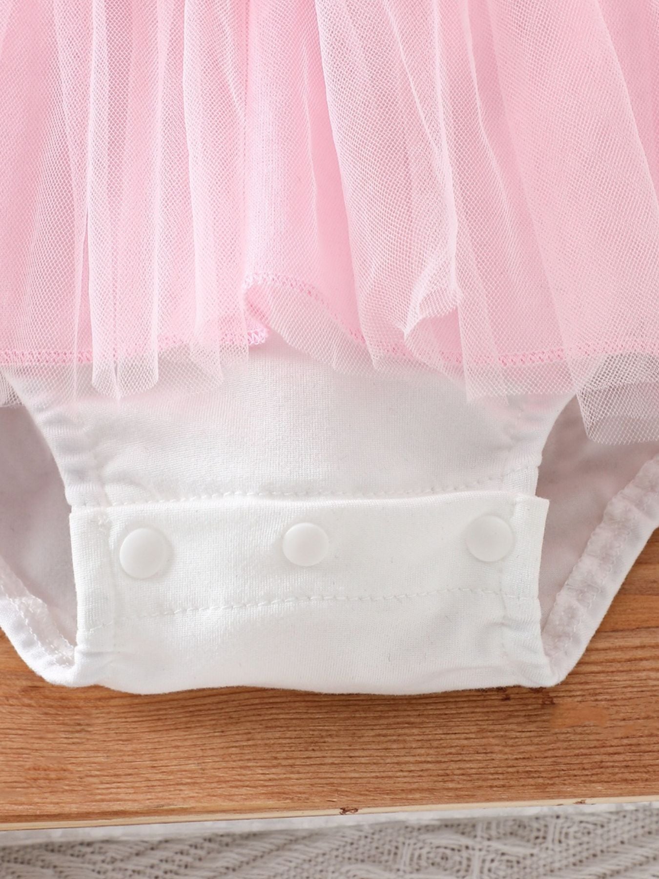 Pink tulle one-piece baby romper with white snap crotch