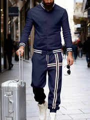 Navy blue men's tracksuit with white stripe details on jacket cuffs and pants.
