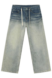 Faded wash wide-leg jeans with drawstring in medium blue denim.