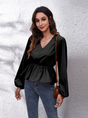 Black peplum blouse with V-neck, gathered waist, and balloon sleeves.