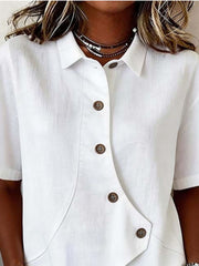 White asymmetrical button front shirt with short sleeves and a collared neckline.