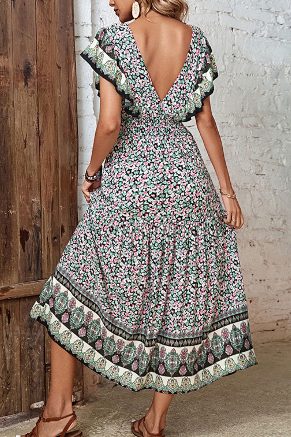 Bohemian floral midi dress with butterfly sleeves, V-neck, and tiered skirt.