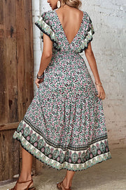 Bohemian floral midi dress with butterfly sleeves, V-neck, and tiered skirt.